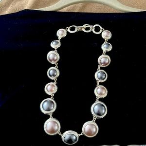 A women’s very short silver and gray necklace